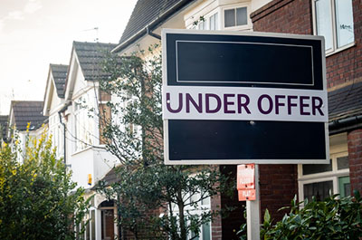 under offer sign outside a house